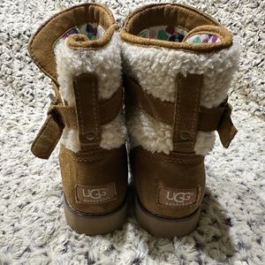 Big Girls’ UGG Australia mid-high slip-on boot.